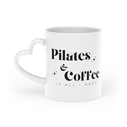 Heart-shaped mug with Pilates & Coffee design from Urban Rhythm Shop, perfect for Pilates enthusiasts.